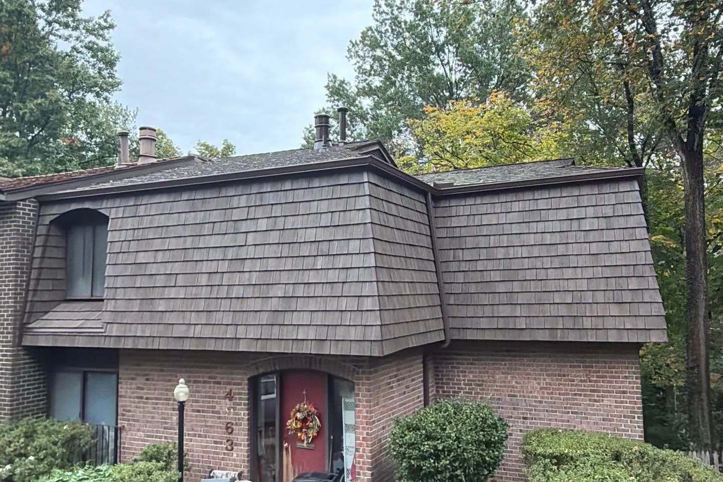Brick home with a new Brava synthetic shake mansard roof