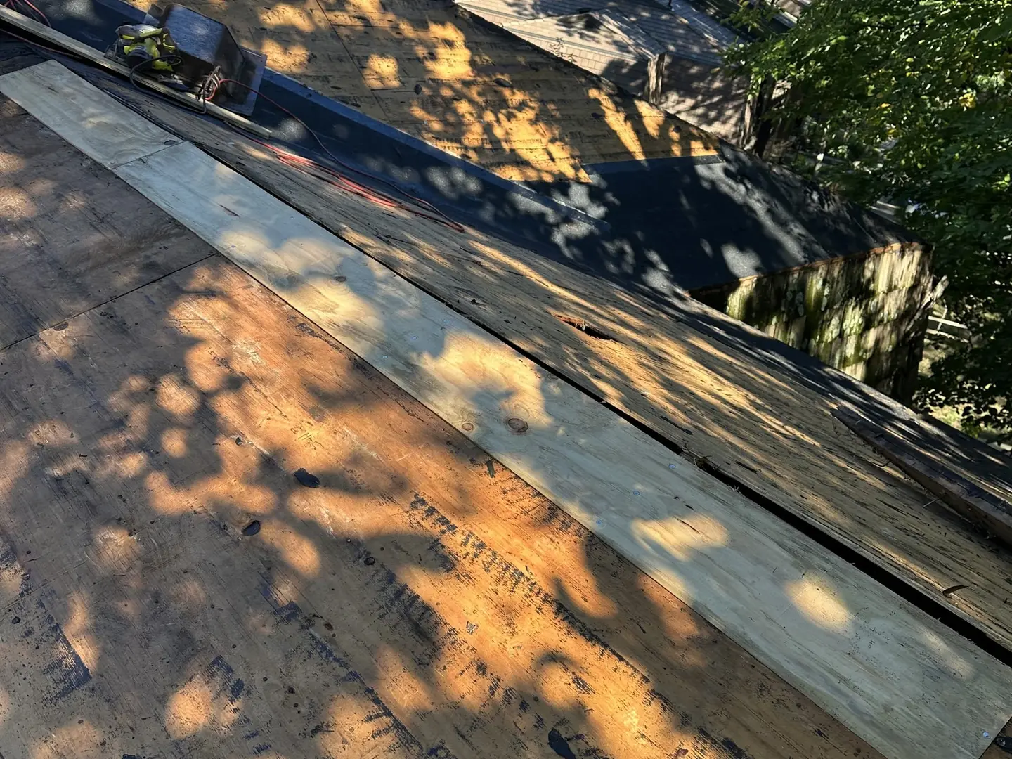 New plywood decking replacing rotted sheets on a roof before underlayment