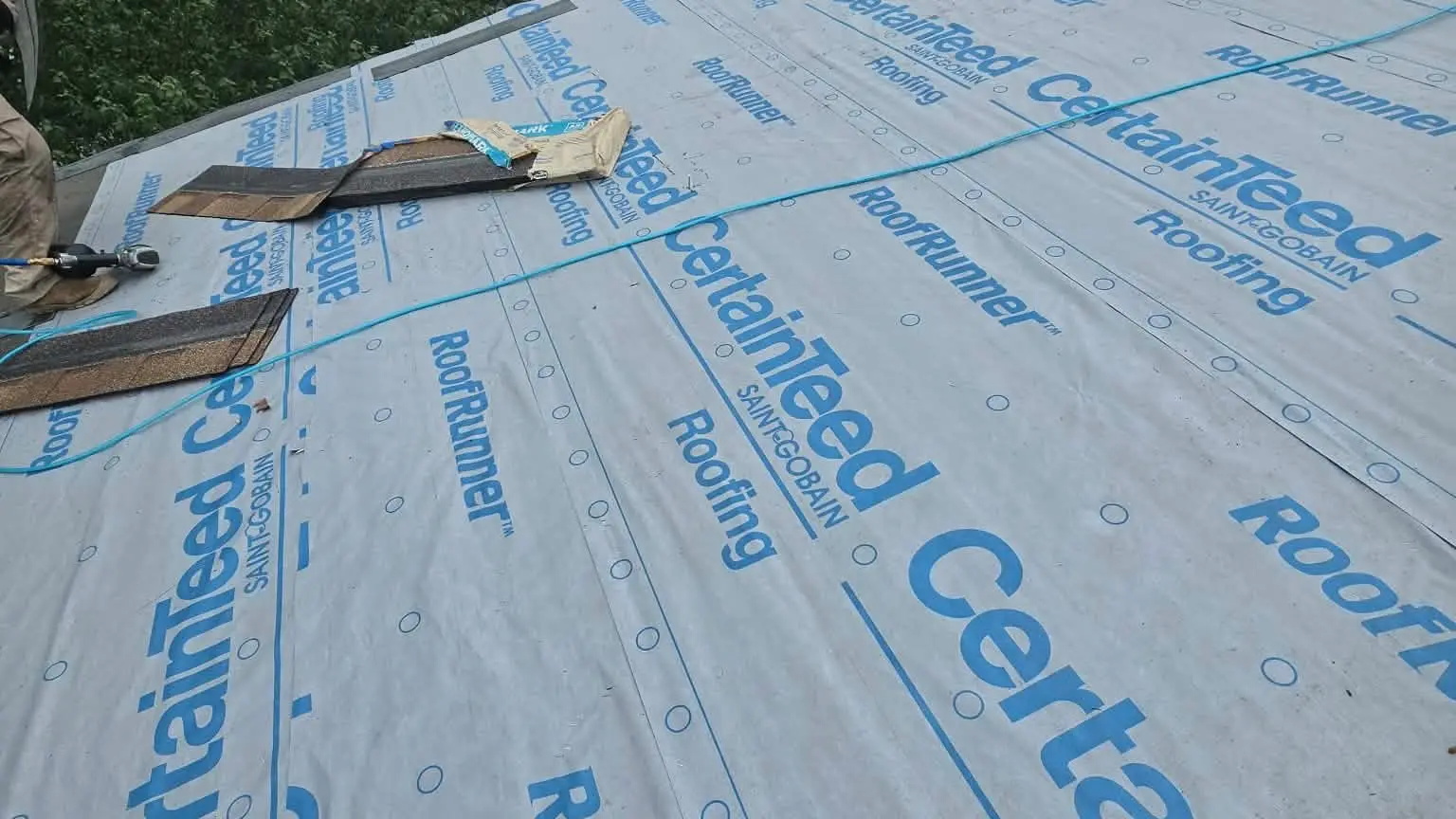 Roof replacement in progress: old shingles removed and new underlayment going down